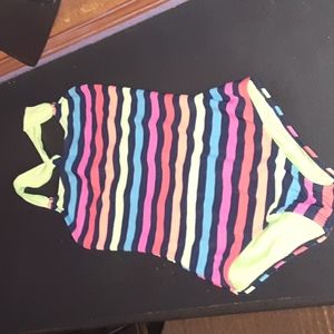 A bathing suit, a romper, sweatpants, and a v-neck shirt